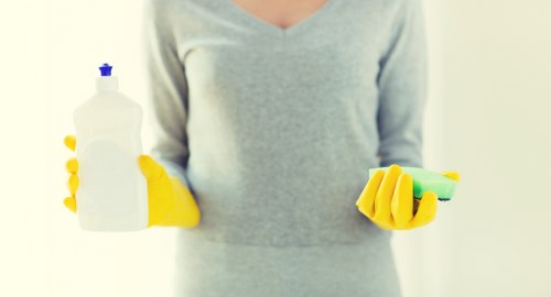 Professional carpet cleaning equipment being used with attention to safety controls